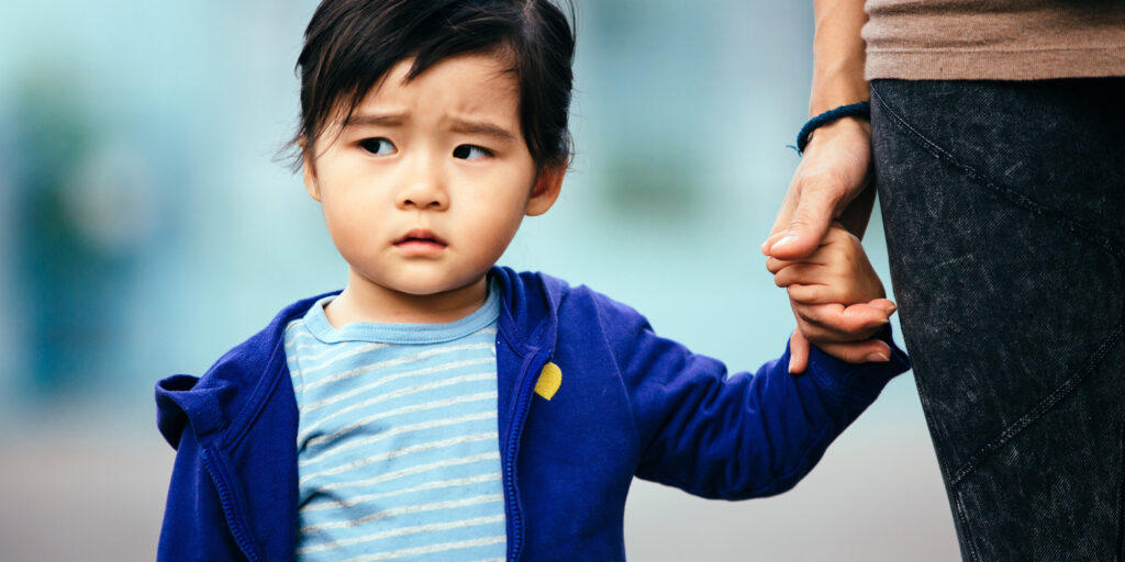 Child holding adult hand